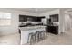 Bright kitchen featuring dark cabinets, granite countertops, stainless steel appliances and island seating at 5101 E Sharbel Rd, San Tan Valley, AZ 85143