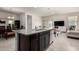 Bright, open kitchen and dining area features stainless appliances, island seating and tiled floors at 5101 E Sharbel Rd, San Tan Valley, AZ 85143