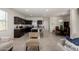 Spacious living area featuring tile floors, a modern island, and seamless flow into the kitchen at 5101 E Sharbel Rd, San Tan Valley, AZ 85143