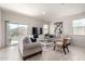 Bright living room featuring neutral tones, tile flooring, and sliding door access to the outdoors at 5101 E Sharbel Rd, San Tan Valley, AZ 85143
