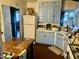 Vintage kitchen with light blue cabinets, a retro refrigerator, and a wooden table at 532 E Cheery Lynn Rd, Phoenix, AZ 85012