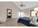 A bright bedroom with vaulted ceiling, ceiling fan, and large mirror at 6334 E Le Marche Ave, Scottsdale, AZ 85254