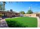 Large backyard with a lush lawn, patio, and mature trees at 7430 E Coronado Rd, Scottsdale, AZ 85257