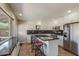Bright kitchen featuring white cabinets, black countertops, stainless steel appliances, and a kitchen island with seating at 7430 E Coronado Rd, Scottsdale, AZ 85257