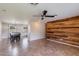Open floor plan with a view into kitchen and dining area with feature wooden wall and ceiling fan at 7430 E Coronado Rd, Scottsdale, AZ 85257