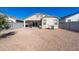 Spacious backyard with gravel, patio, and low-maintenance landscaping, ideal for outdoor activities at 7749 W Florence Ave, Phoenix, AZ 85043