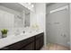 Bright bathroom featuring a vanity with modern fixtures and a large mirror at 7749 W Florence Ave, Phoenix, AZ 85043