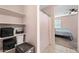 Bathroom featuring built-in storage and an adjacent bedroom showcases convenient and functional design at 7749 W Florence Ave, Phoenix, AZ 85043