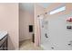 Well-lit bathroom equipped with a walk-in shower and modern fixtures, designed for comfort and accessibility at 7749 W Florence Ave, Phoenix, AZ 85043