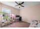 Inviting bedroom designed as a home office and featuring natural light, ceiling fan, and comfortable seating at 7749 W Florence Ave, Phoenix, AZ 85043