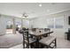 A dining room features a modern table and chairs adjacent to sliding glass doors leading to the backyard at 7749 W Florence Ave, Phoenix, AZ 85043
