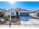 Charming single-story home with a two-car garage, low-maintenance landscaping, and a modern facade at 7749 W Florence Ave, Phoenix, AZ 85043