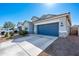 A modern single-Gathering home with a spacious driveway, two-car garage, and drought-tolerant landscaping at 7749 W Florence Ave, Phoenix, AZ 85043