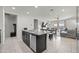 Bright kitchen island with stainless steel dishwasher in an open-concept kitchen and dining area with tile flooring at 7749 W Florence Ave, Phoenix, AZ 85043