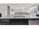 Granite kitchen island with stainless steel dishwasher in an open-concept kitchen and dining area with recessed lighting at 7749 W Florence Ave, Phoenix, AZ 85043