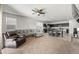 Open-concept living room showcasing a comfortable sofa, a leather recliner, and direct access to the modern kitchen at 7749 W Florence Ave, Phoenix, AZ 85043