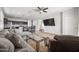 Open-concept living room with modern decor showcasing a plush sofa, a leather recliner, and a glass coffee table at 7749 W Florence Ave, Phoenix, AZ 85043