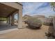 Desert landscaping and tan stucco exterior in this relaxing backyard at 9142 E La Posada Ct, Scottsdale, AZ 85255