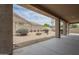 Desert landscaped backyard with rock ground cover, mature plants, and covered patio at 9142 E La Posada Ct, Scottsdale, AZ 85255