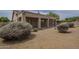 Lush backyard featuring a gravel ground cover, mature plants, cactus, and covered patio at 9142 E La Posada Ct, Scottsdale, AZ 85255