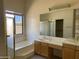 This bathroom boasts dual sinks, a vanity area, a soaking tub with jets, and a glass-enclosed shower at 9142 E La Posada Ct, Scottsdale, AZ 85255