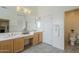 Bathroom featuring double sinks, ample counter space, and a separate toilet area at 9142 E La Posada Ct, Scottsdale, AZ 85255