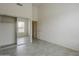 Bright bedroom features neutral walls, tile flooring, window, and closet with mirrored sliding doors at 9142 E La Posada Ct, Scottsdale, AZ 85255