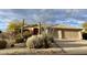 Charming single-story home with a desert landscaped front yard and attached two-car garage at 9142 E La Posada Ct, Scottsdale, AZ 85255