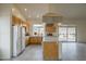Well-lit kitchen featuring an island cooktop, tile flooring, and backyard views at 9142 E La Posada Ct, Scottsdale, AZ 85255