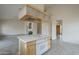 Spacious kitchen island with cooktop, tile flooring, and easy access to front entry and living room at 9142 E La Posada Ct, Scottsdale, AZ 85255