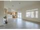 Bright living room features tile flooring, a sliding door to the backyard, and is open to the kitchen at 9142 E La Posada Ct, Scottsdale, AZ 85255