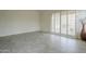 Living area with tile flooring, shuttered glass doors, and high ceilings at 9142 E La Posada Ct, Scottsdale, AZ 85255