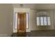 View of the living room featuring a tile floor, a front door and windows with shutters at 9142 E La Posada Ct, Scottsdale, AZ 85255