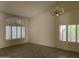 Spacious living room with shuttered windows and chandelier provides lots of natural light at 9142 E La Posada Ct, Scottsdale, AZ 85255