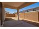This home features a covered patio with a concrete slab and a backyard with block wall fencing at 11623 W Green Dr, Youngtown, AZ 85363