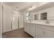 Bathroom showcasing a tiled floor, glass shower door, and double sink vanity at 11623 W Green Dr, Youngtown, AZ 85363