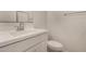 Well-lit bathroom featuring a modern vanity with a large sink and a matching toilet at 11623 W Green Dr, Youngtown, AZ 85363