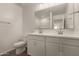 Bathroom featuring a double sink vanity, toilet, and large mirror above the sinks at 11623 W Green Dr, Youngtown, AZ 85363
