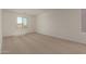 Spacious bedroom with neutral carpeting and ample natural light from a large window at 11623 W Green Dr, Youngtown, AZ 85363
