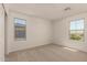 Serene bedroom with neutral carpet, two large windows, and ample natural light, creating a peaceful retreat at 11623 W Green Dr, Youngtown, AZ 85363