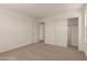 Bright, carpeted bedroom features a closet with sliding doors and an open doorway at 11623 W Green Dr, Youngtown, AZ 85363