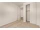 Comfortable bedroom with neutral carpeting, a closet with sliding doors, and a doorway to another room at 11623 W Green Dr, Youngtown, AZ 85363