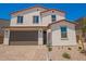 Charming two-story home with a two-car garage and a well-manicured front yard, showcasing its inviting curb appeal at 11623 W Green Dr, Youngtown, AZ 85363