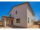 Back exterior featuring a stucco facade, terra cotta tile roof, and covered patio at 11623 W Green Dr, Youngtown, AZ 85363
