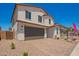 Two-story home featuring desert landscaping and a two-car garage at 11623 W Green Dr, Youngtown, AZ 85363