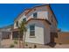 Two-story home with a clay tile roof, neutral stucco and desert landscaping at 11623 W Green Dr, Youngtown, AZ 85363