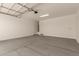 Spacious two-car garage featuring concrete floors, ample lighting, and access to the home's interior at 11623 W Green Dr, Youngtown, AZ 85363