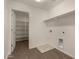 Functional laundry room featuring tile flooring, washer/dryer hookups, and shelving with an adjacent pantry at 11623 W Green Dr, Youngtown, AZ 85363