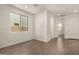 Bright and open living room featuring wood-look tile flooring, creating a versatile and welcoming space at 11623 W Green Dr, Youngtown, AZ 85363