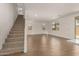 Spacious open-concept living room with staircase, wood tile flooring and plenty of natural light, perfect for Gathering gatherings at 11623 W Green Dr, Youngtown, AZ 85363